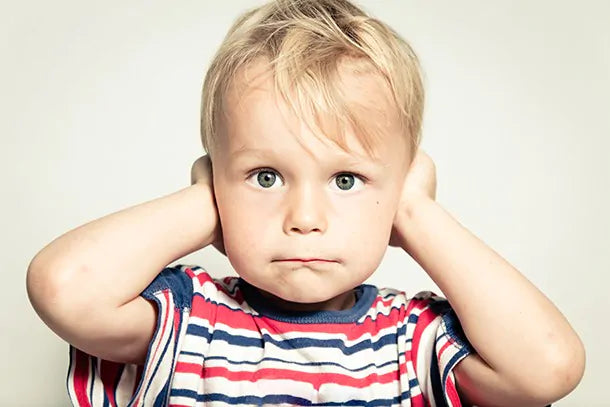 child blocking ears from noise