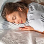 Woman comfortably sleeping on her side on a soft pillow