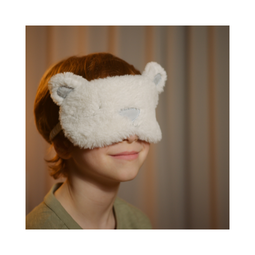 Smiling child wearing fluffy animal-themed sleep mask