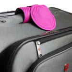 Durable luggage tag attached to grey suitcase