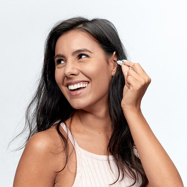 lady inserting party earplugs