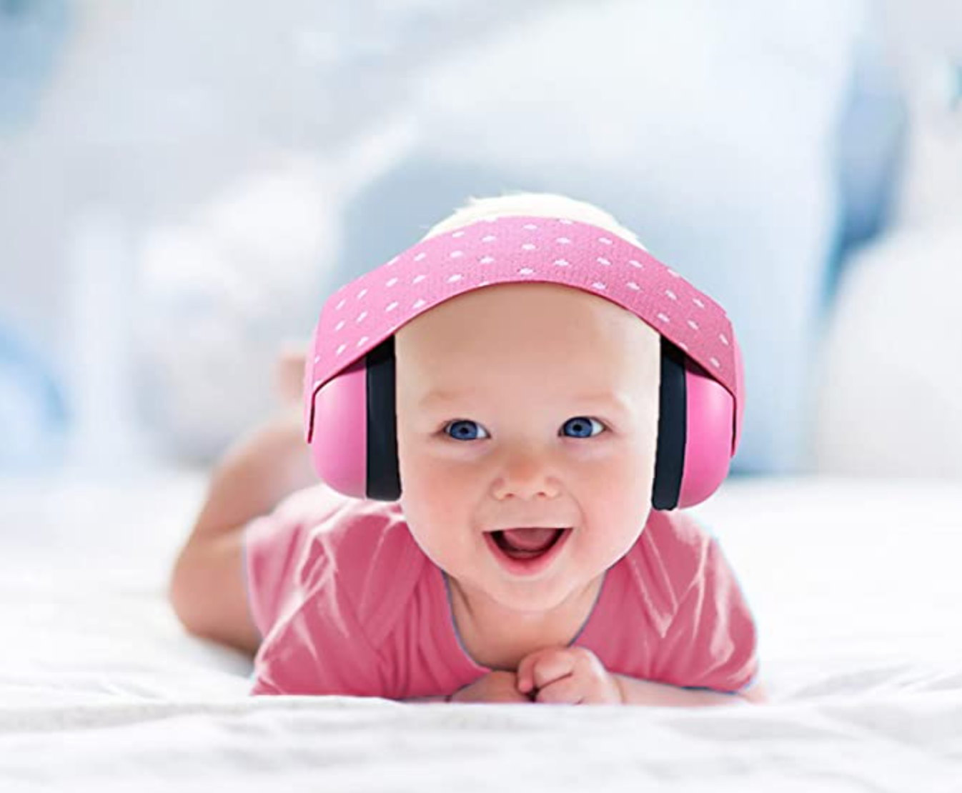 baby wearing pink hushies earmuffs
