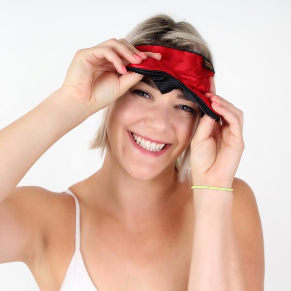 Lady Peaking out from under red silk sleep mask