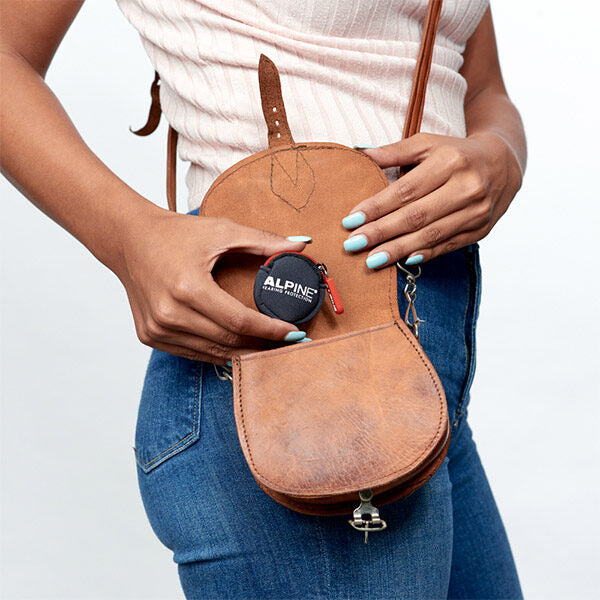 putting party earplugs in handbag