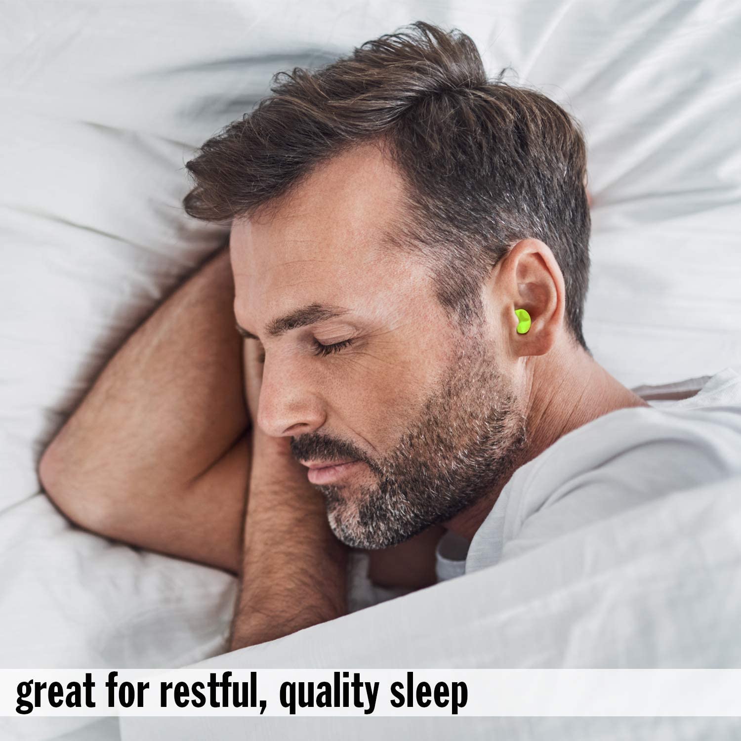 man wearing ear plugs for snoring