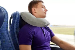 Man Sleeping while travelling with inflatable pillow