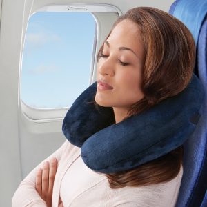 lady sleeping with inflatable pillow on plane