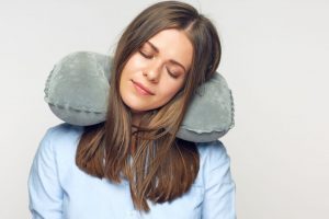 Lady Sleeping with Travel Pillow 