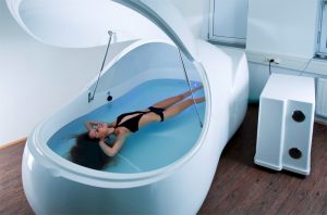 lady in float tank wearing waterproof earplugs 