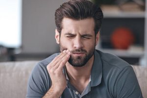 Man with sore jaw needs Mouth Guard for Teeth Grinding