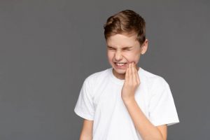 kid with sore mouth from teeth grinding