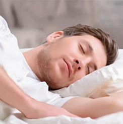 man sleeping with best noise blocking earplugs