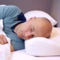 man sleeping on posiform anti snoring pillow