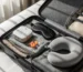 Travel sleep kit essentials arranged in a suitcase.